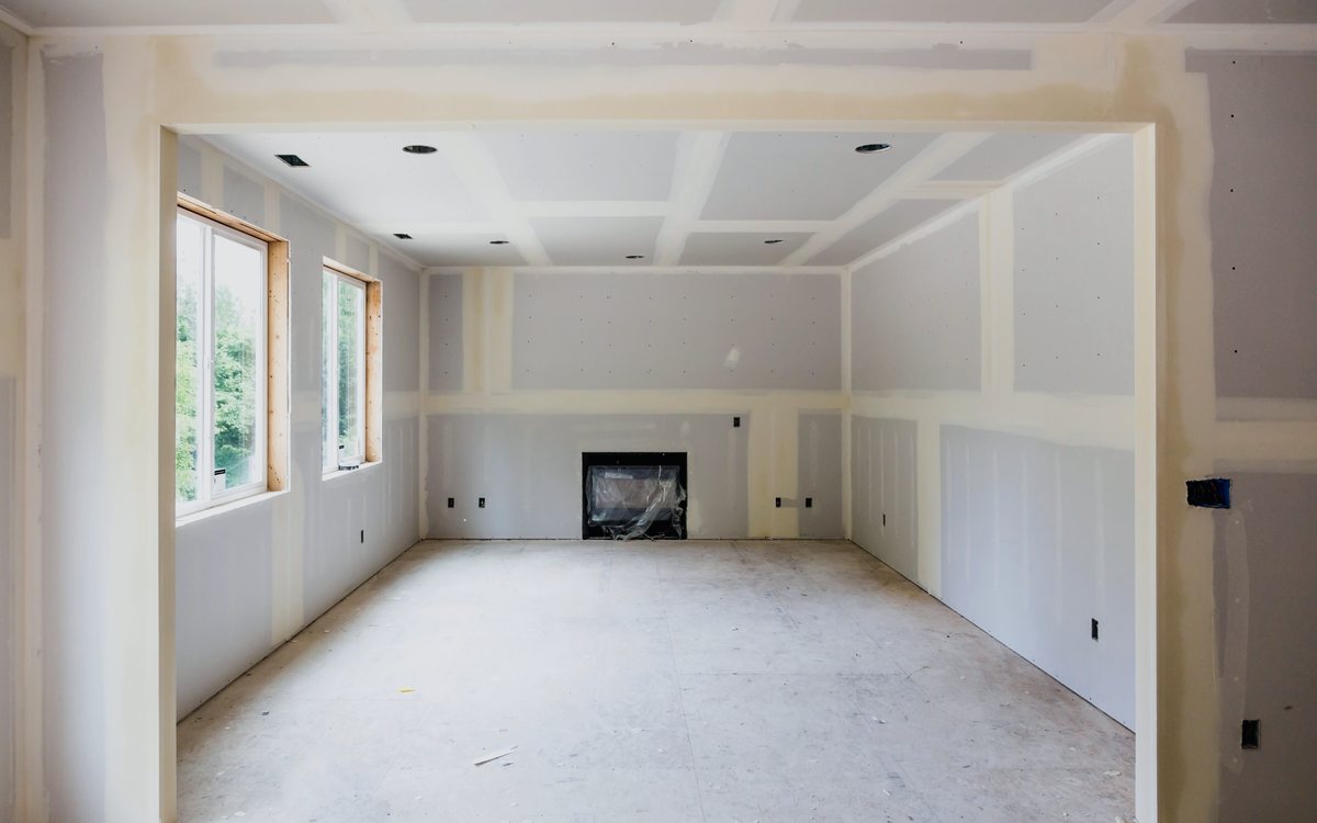 Room with drywall hung and taped, seams floated smooth and ready for primer and paint