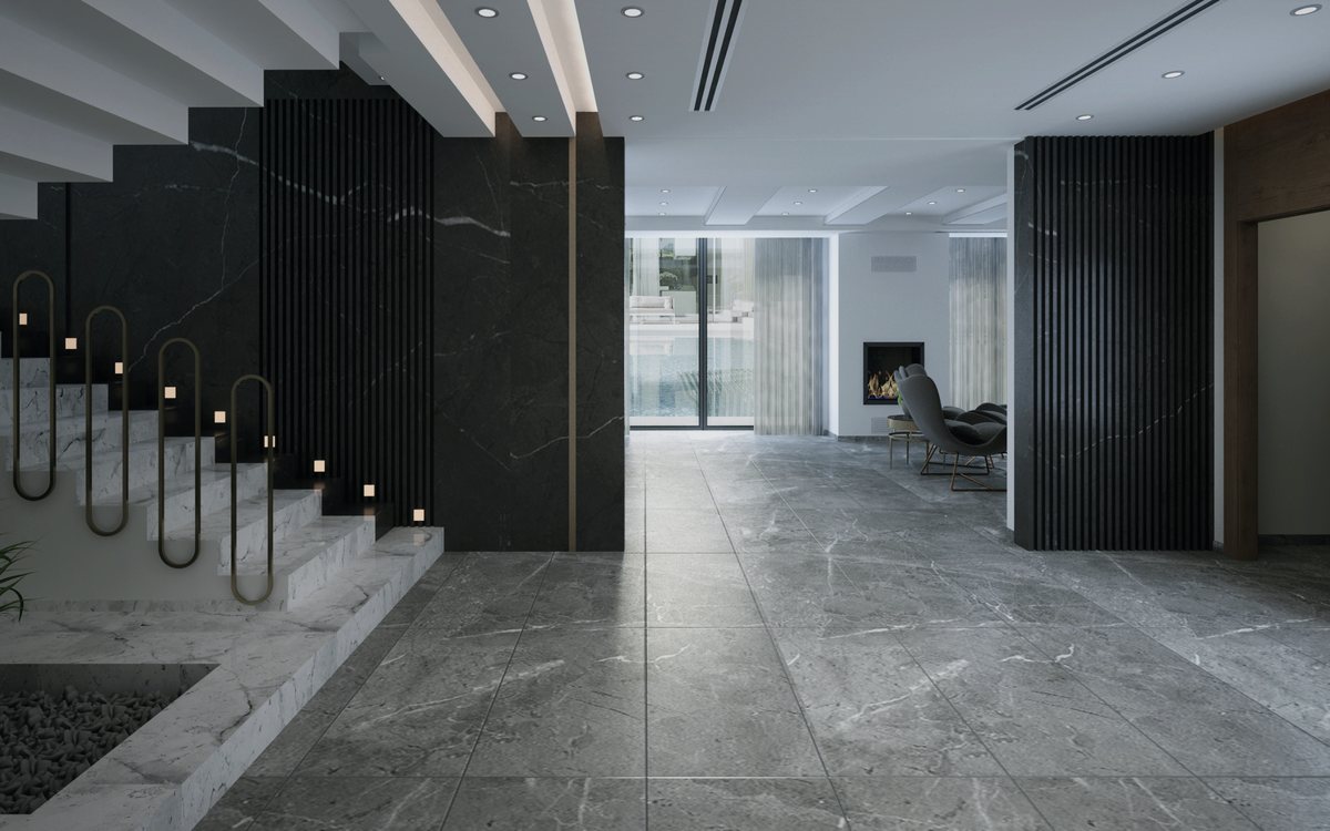 Large format natural stone tile flooring in an entry and stair hall with a polished finish