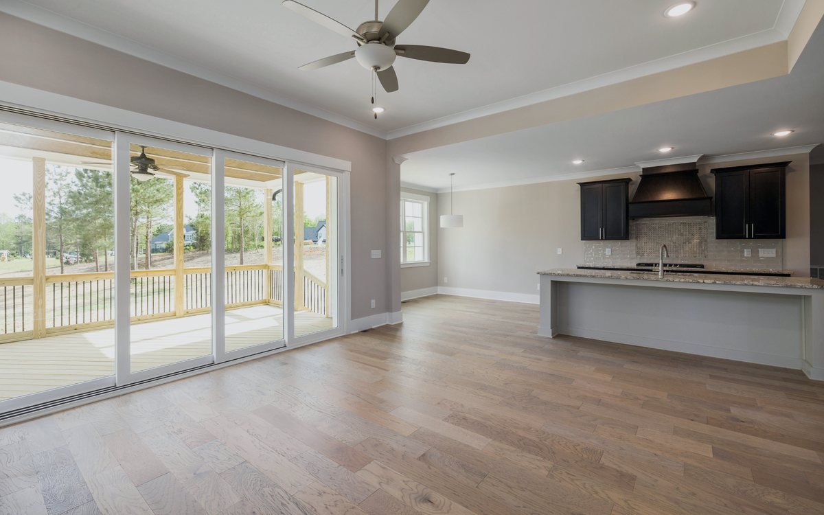 Wide plank wood flooring running through an open living area into the kitchen of a Santa Clarita Valley home