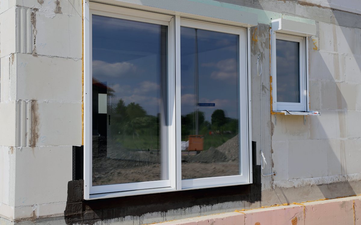 New sliding window set into a prepared rough opening with the exterior trim and flashing still to be finished
